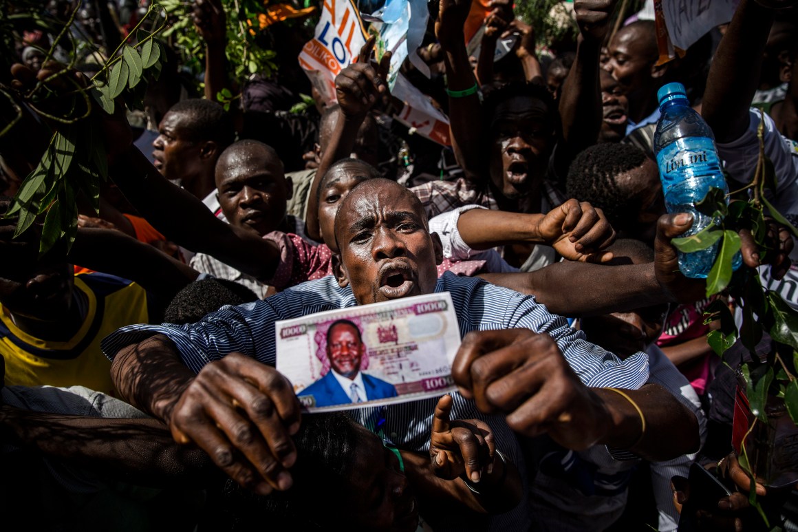 Supporters react before the Kenyan opposition National Super Alliance (NASA) coalition leader has himself sworn in as the 'people's president' on January 30th, 2018 in Nairobi. Kenyan opposition leader Raila Odinga had himself sworn in as an alternative president in front of thousands of supporters, three months after an election he claims was stolen from him.