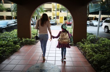 An immigrant woman takes her daughter to school before going to work on February 9th, 2018, in Miami, Florida.