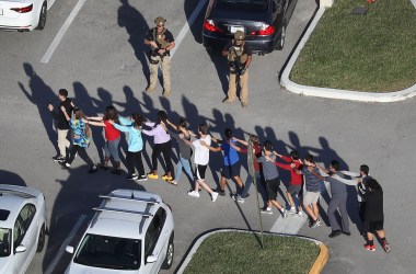 People are brought out of the Marjory Stoneman Douglas High School after a shooting on February 14th, 2018, in Parkland, Florida.