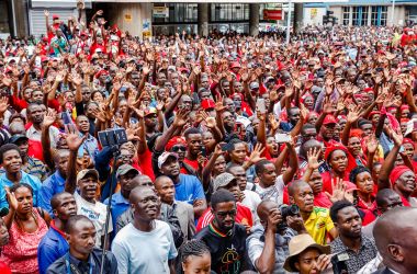 Supporters of the Zimbabwe opposition party, the Movement for Democratic Change, listen and cheer as the party's acting president addresses the crowd gathered outside the party headquarters in Harare, Zimbabwe, on February 15th, 2018, following the death of the former opposition leader, Morgan Tsvangirai.