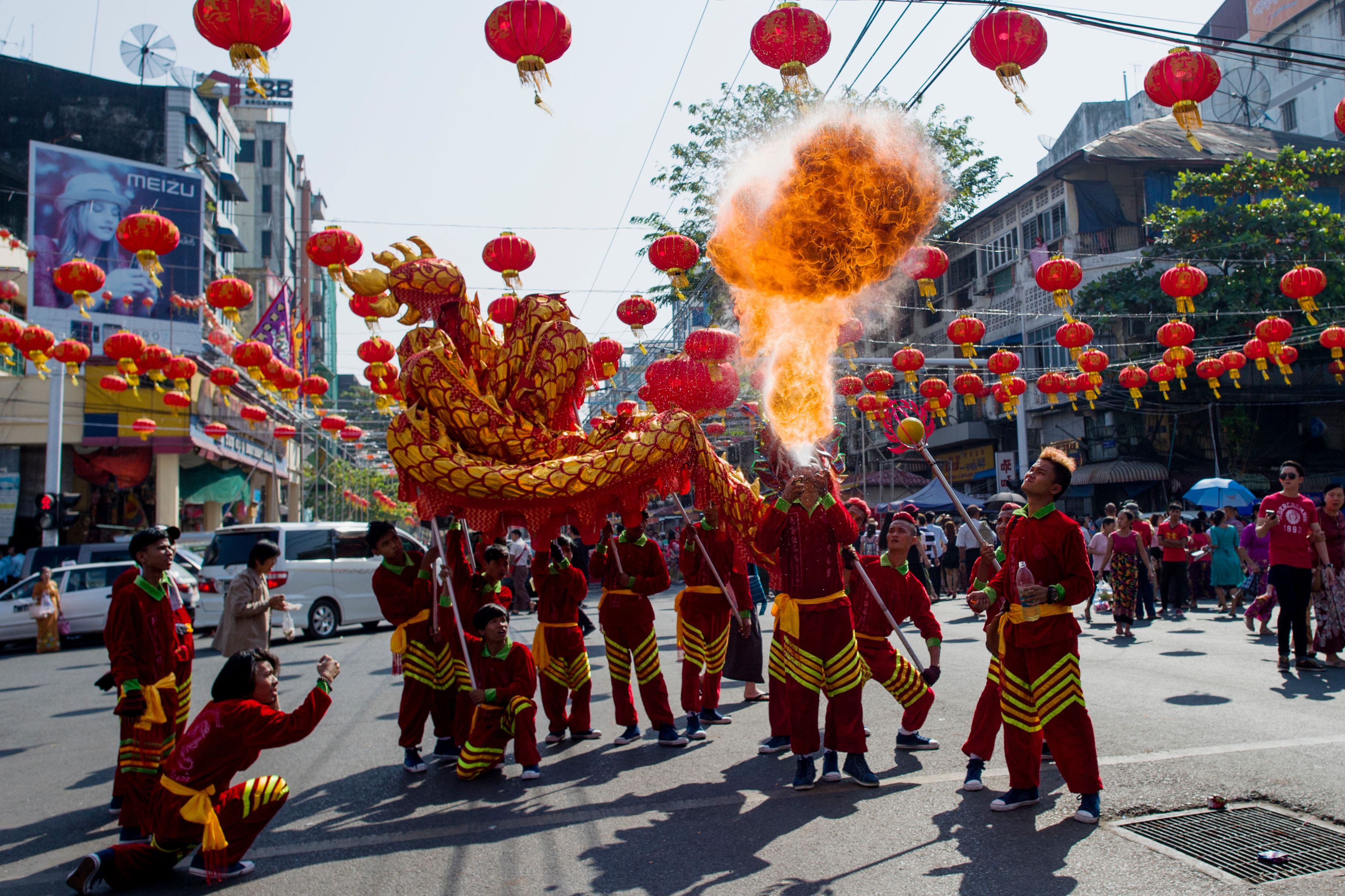 A fire breather blows flames in a traditional dragon dance on the first day of the Lunar New Year in the Chinatown district of Yangon, Myanmar, on February 16th, 2018.