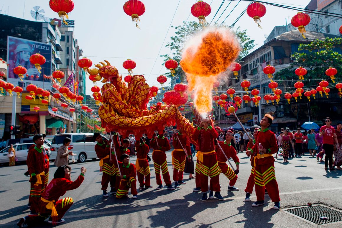 A fire breather blows flames in a traditional dragon dance on the first day of the Lunar New Year in the Chinatown district of Yangon, Myanmar, on February 16th, 2018.