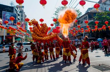 A fire breather blows flames in a traditional dragon dance on the first day of the Lunar New Year in the Chinatown district of Yangon, Myanmar, on February 16th, 2018.