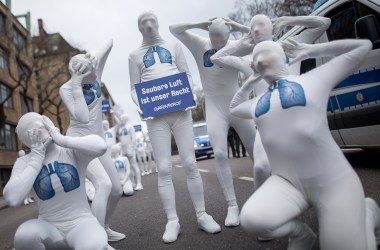 Greenpeace activists hold a poster reading "We Have the Right to Clean Air" as they stage an action against diesel exhaust on February 19th, 2018, in Stuttgart, Germany. A verdict of Germany's Federal Administrative Court is expected on February 22nd, ruling whether cities with high nitrogen oxide pollution could be allowed to ban diesel cars.