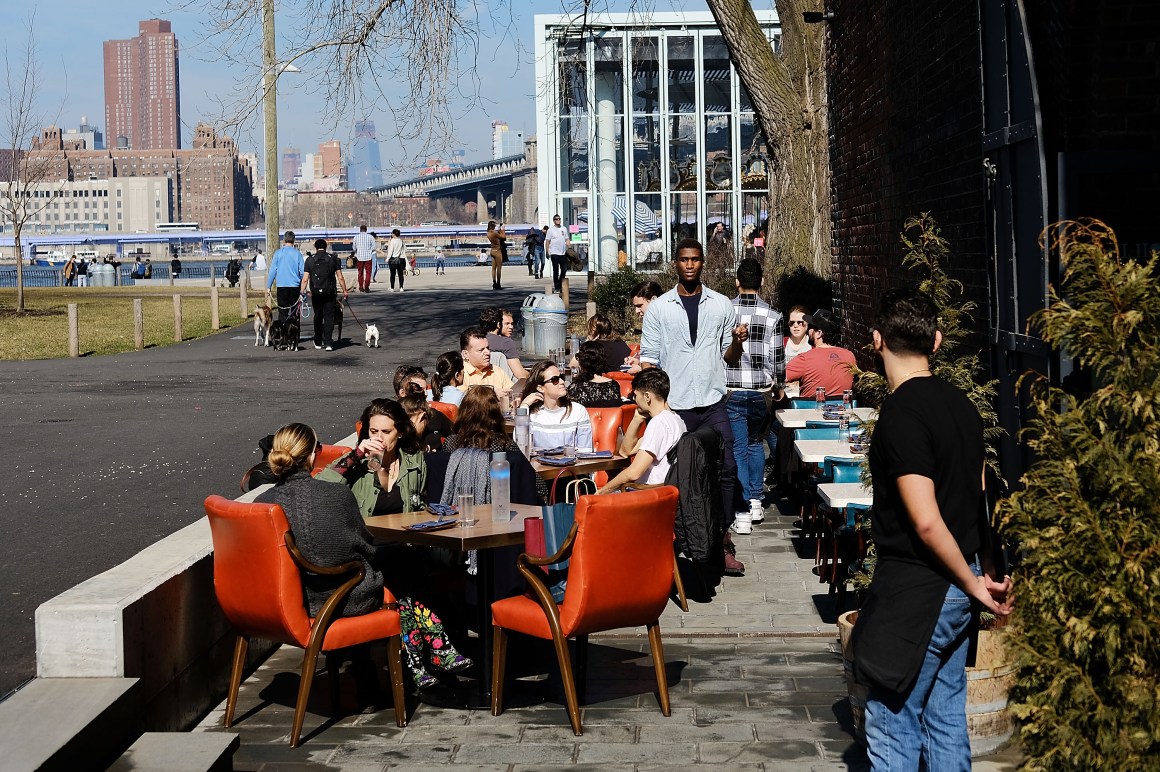 People eat outside in a Brooklyn neighborhood.