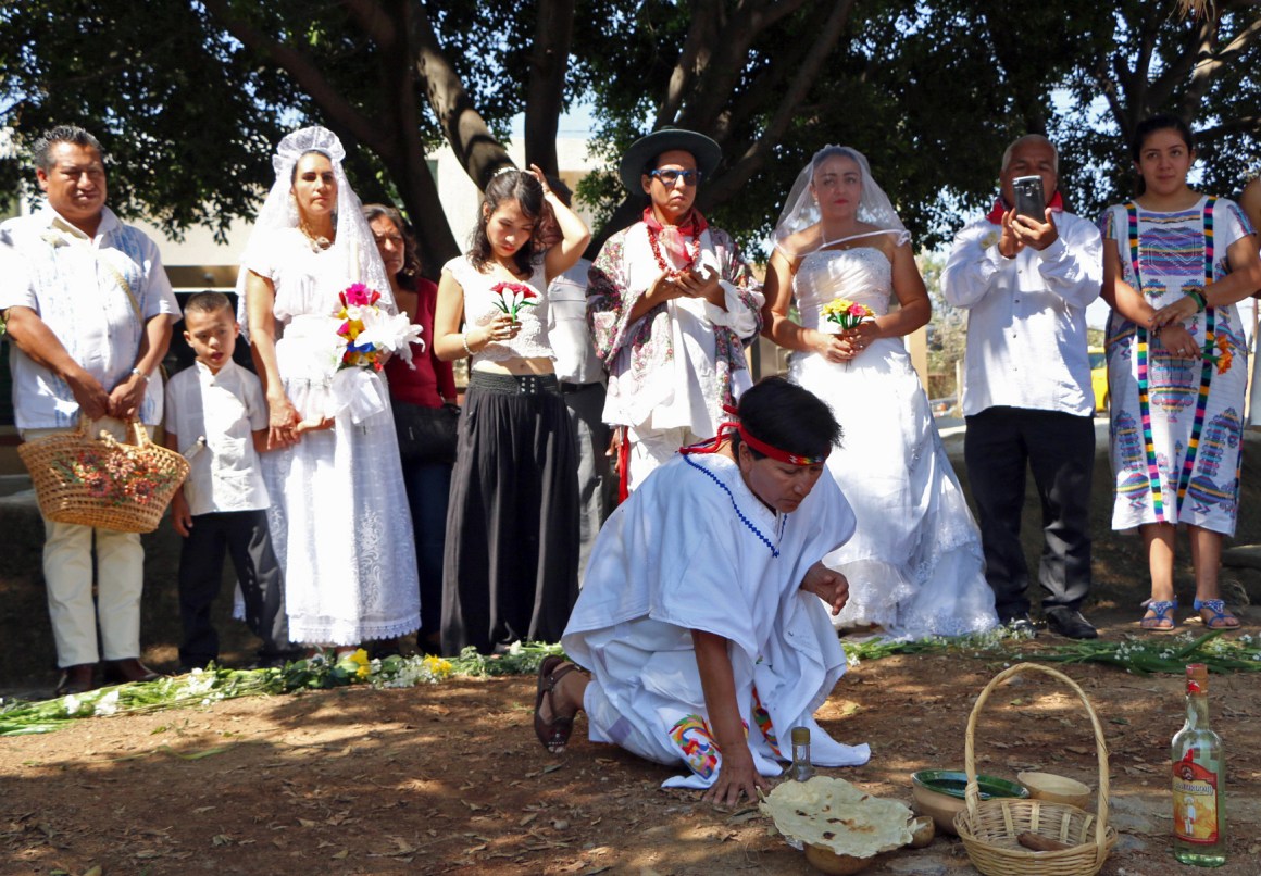 A group of environmental activists hold a traditional ceremony during an event called Marry a Tree, in the community of San Jacinto Amilpas, Mexico, on February 25th, 2018. Marry a Tree began as a ritual of giving thanks to Mother Earth carried out by the organization Bedani; it later gave way to a symbolic wedding based on Inca customs where women and men marry trees in a rite led by Peruvian actor and environmentalist Richard Torres.