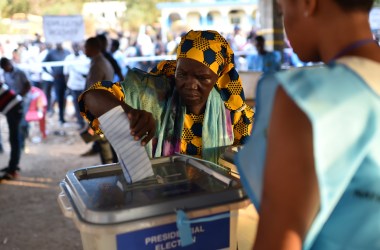 A women cast her ballot as part of the general elections, on March 7th, 2018, at a polling station in Freetown.