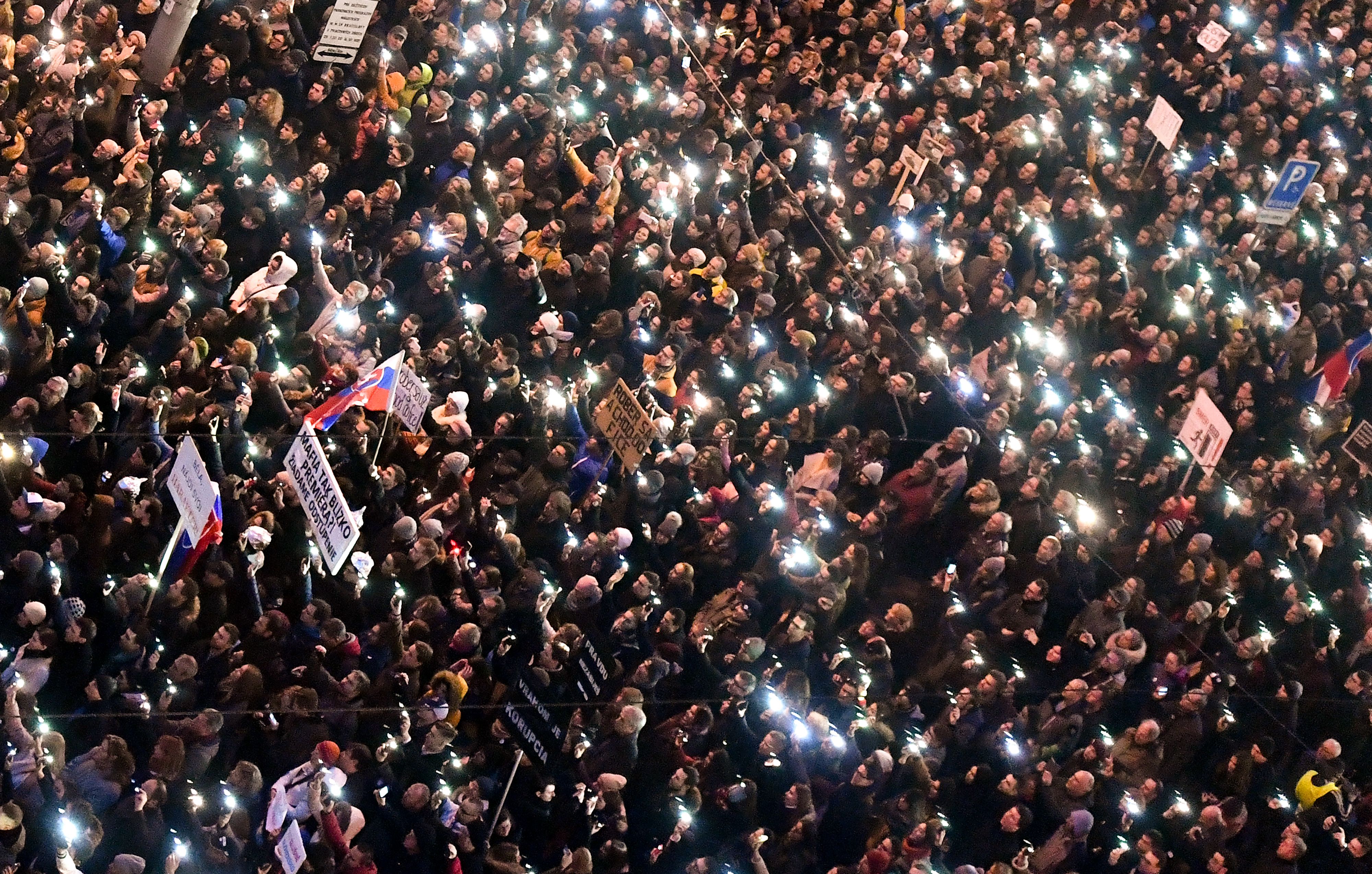 People gather near the Slovak National Uprising square on March 9th, 2018, during a rally against alleged political corruption, where they pay tribute to murdered Slovak journalist Jan Kuciak and his fiancee Martina Kusnirova in Bratislava, Slovakia.