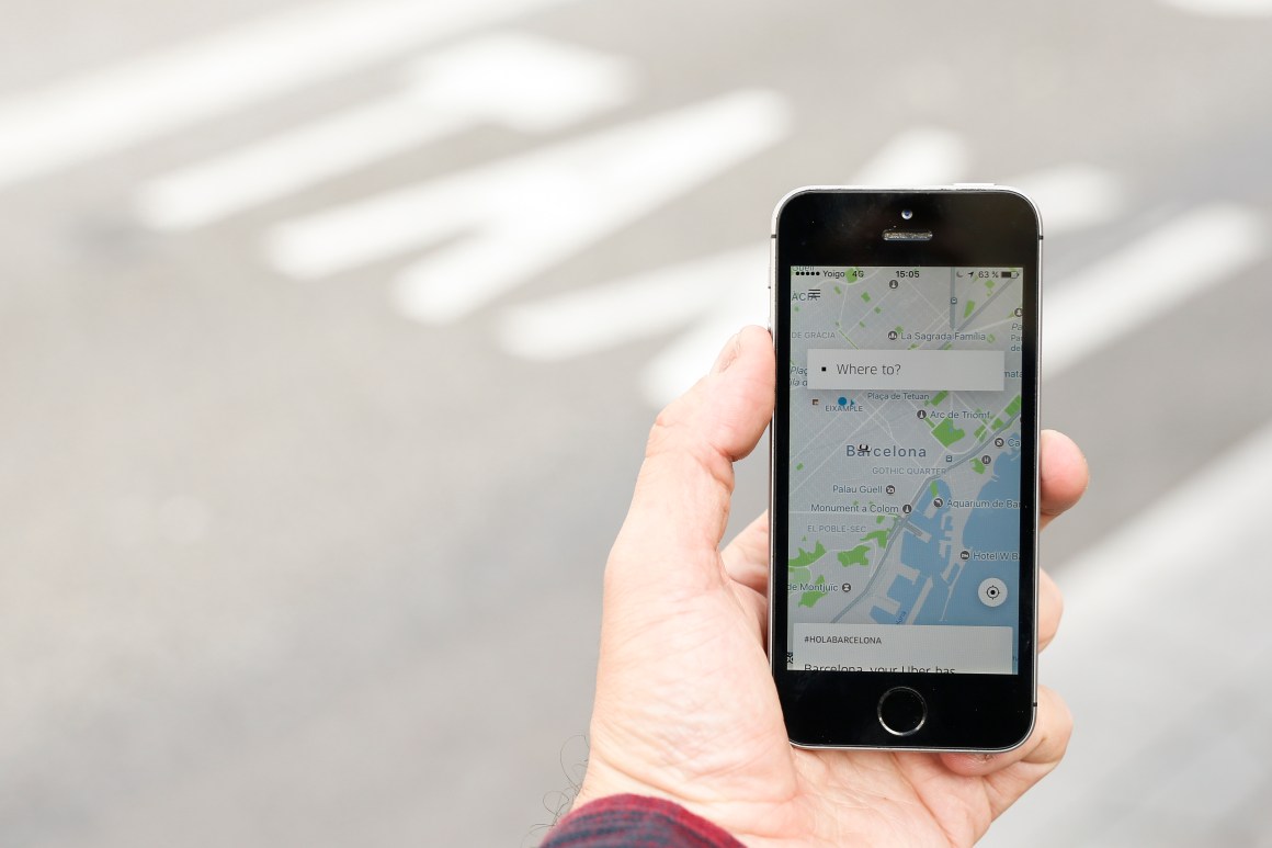 A phone displays the Uber app on March 13th, 2018.