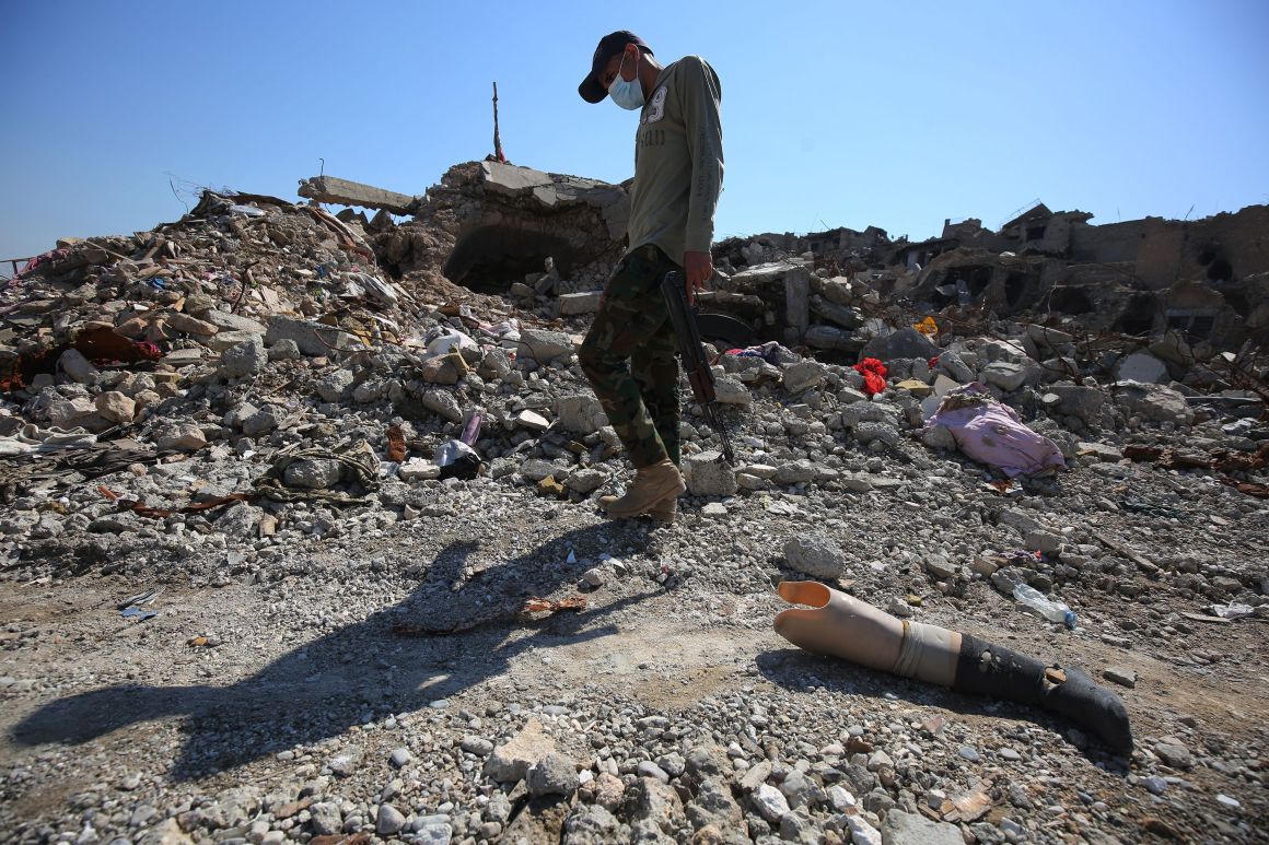 An Iraqi man walks past a prosthetic leg in a residential area in the Old City of Mosul, Iraq, on March 13th, 2018, eight months after Iraqi forces liberated the city from the control of the Islamic State.