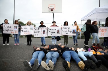 James Logan High School students hold signs honoring students killed at Marjory Stoneman Douglas High School as they observe a moment of silence during a walk out demonstration in Union City, California.