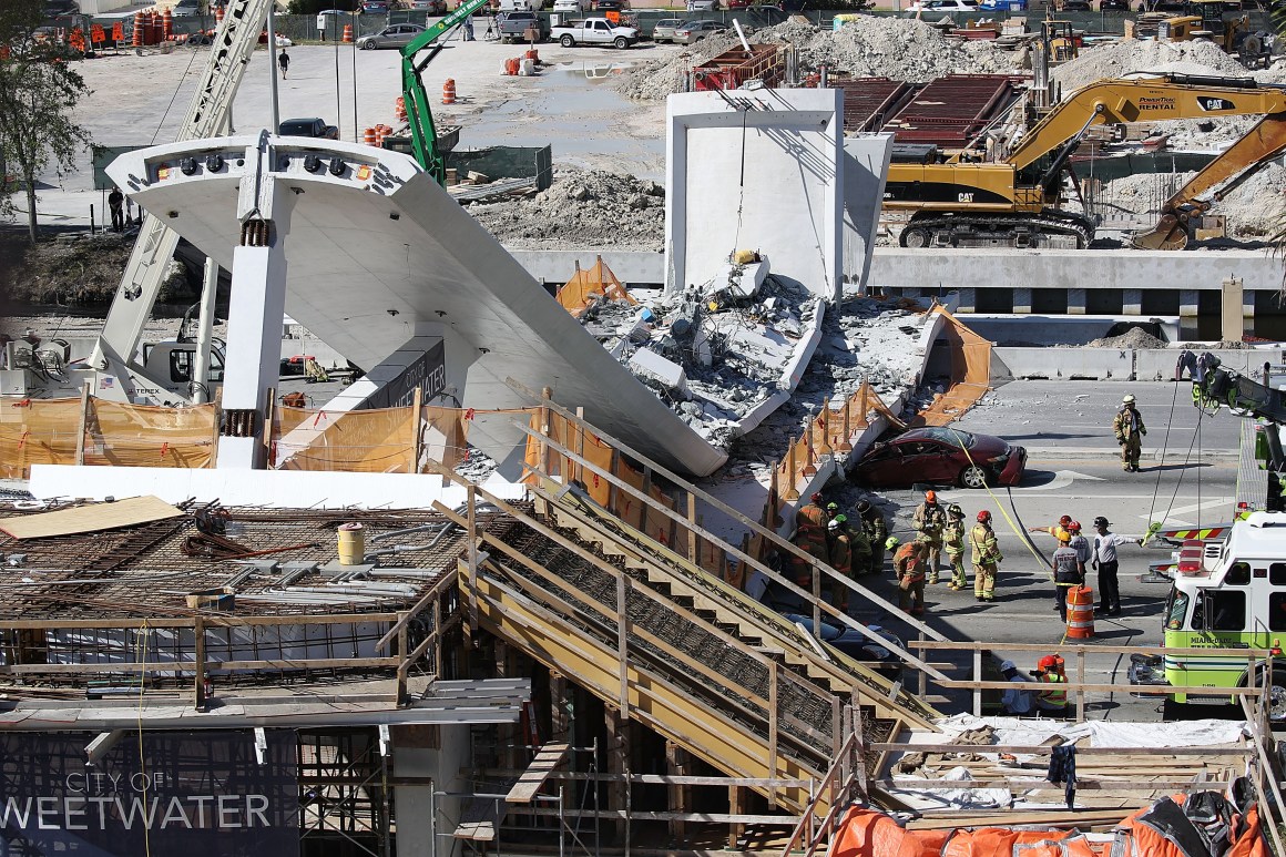 Miami-Dade Fire Rescue Department personnel and other rescue units work at the scene where a pedestrian bridge collapsed a few days after it was built in Miami, Florida.