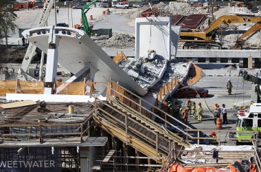 Miami-Dade Fire Rescue Department personnel and other rescue units work at the scene where a pedestrian bridge collapsed a few days after it was built in Miami, Florida.