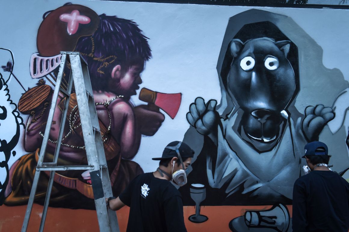 Graffiti artists depict construction tycoon Premchai Karnasuta (left) next to a black panther in Bangkok, Thailand, on March 16th, 2018. This is the latest subversive depiction of an animal that has come to symbolize wild cat-poaching injustice.