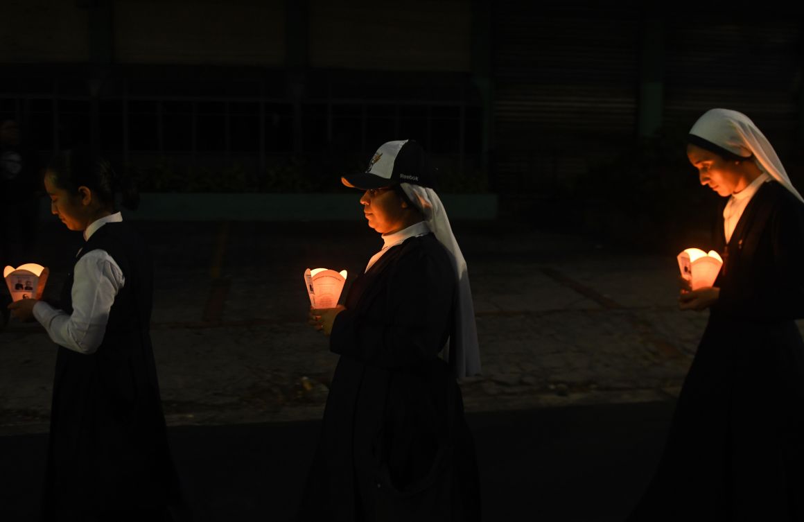 Young Catholic faithfuls take part in vigil commemorating the 38th anniversary of the assassination of Salvadorean Archbishop Oscar Arnulfo Romero.