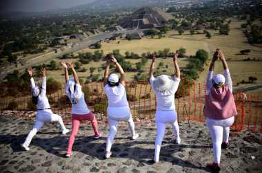 Women atop the Pyramid of the Sun at the archaeological site of Teotihuacan, Mexico, stretch and get energy from the rising sun during celebrations of the spring equinox on March 21st, 2018.