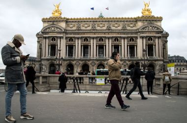 People walk in front of the Garnier Opera House in Paris, France, on March 21st, 2018.