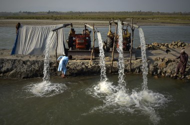 Pakistani farmers use tractors at the Kabul River to pump water used for field irrigation on the outskirts of Peshawar, Pakistan, on March 22nd, 2018.