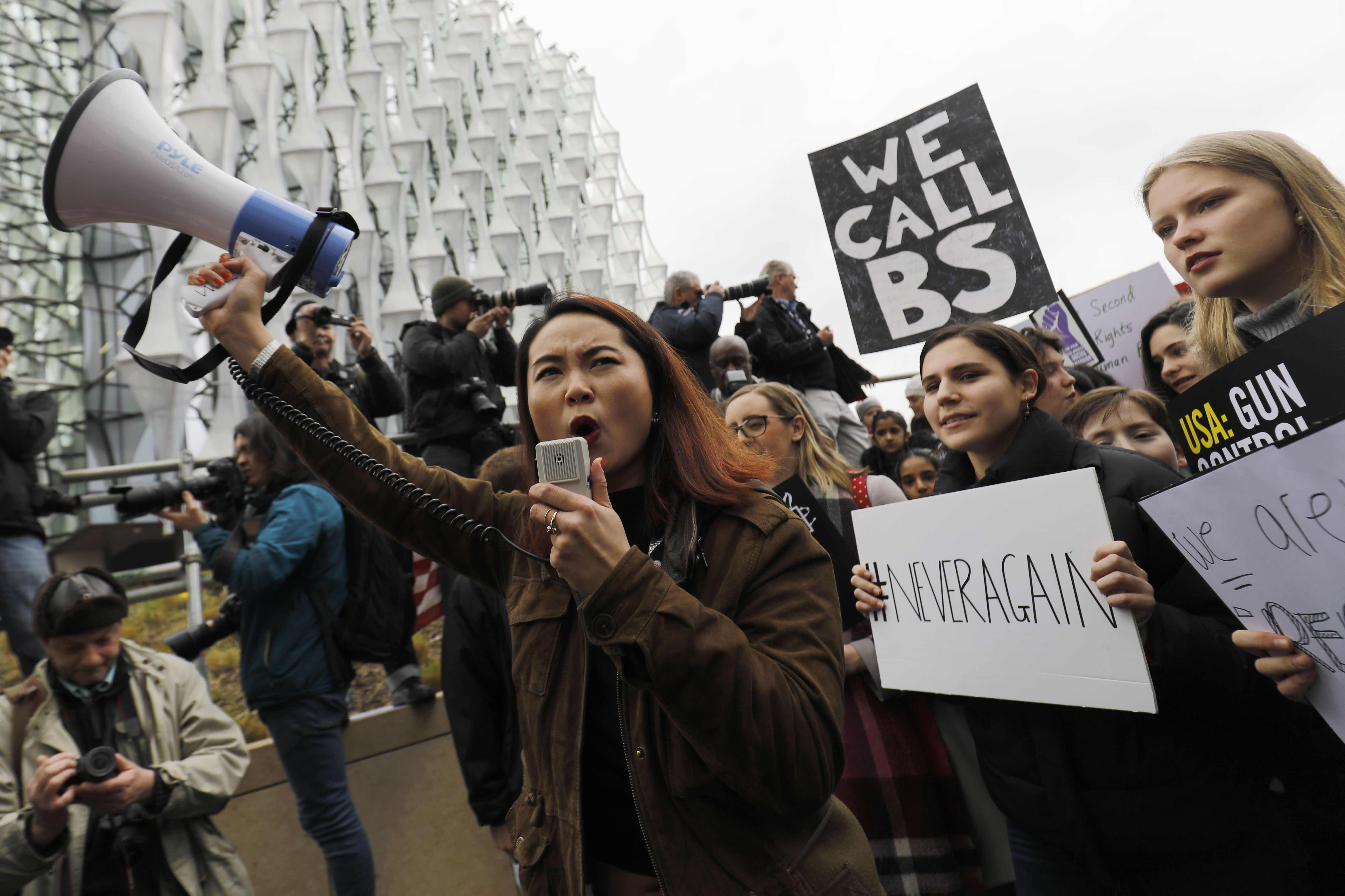 Protesters carry placards and shout slogans during a demonstration calling for greater gun control outside the U.S. Embassy in south London on March 24th, 2018.