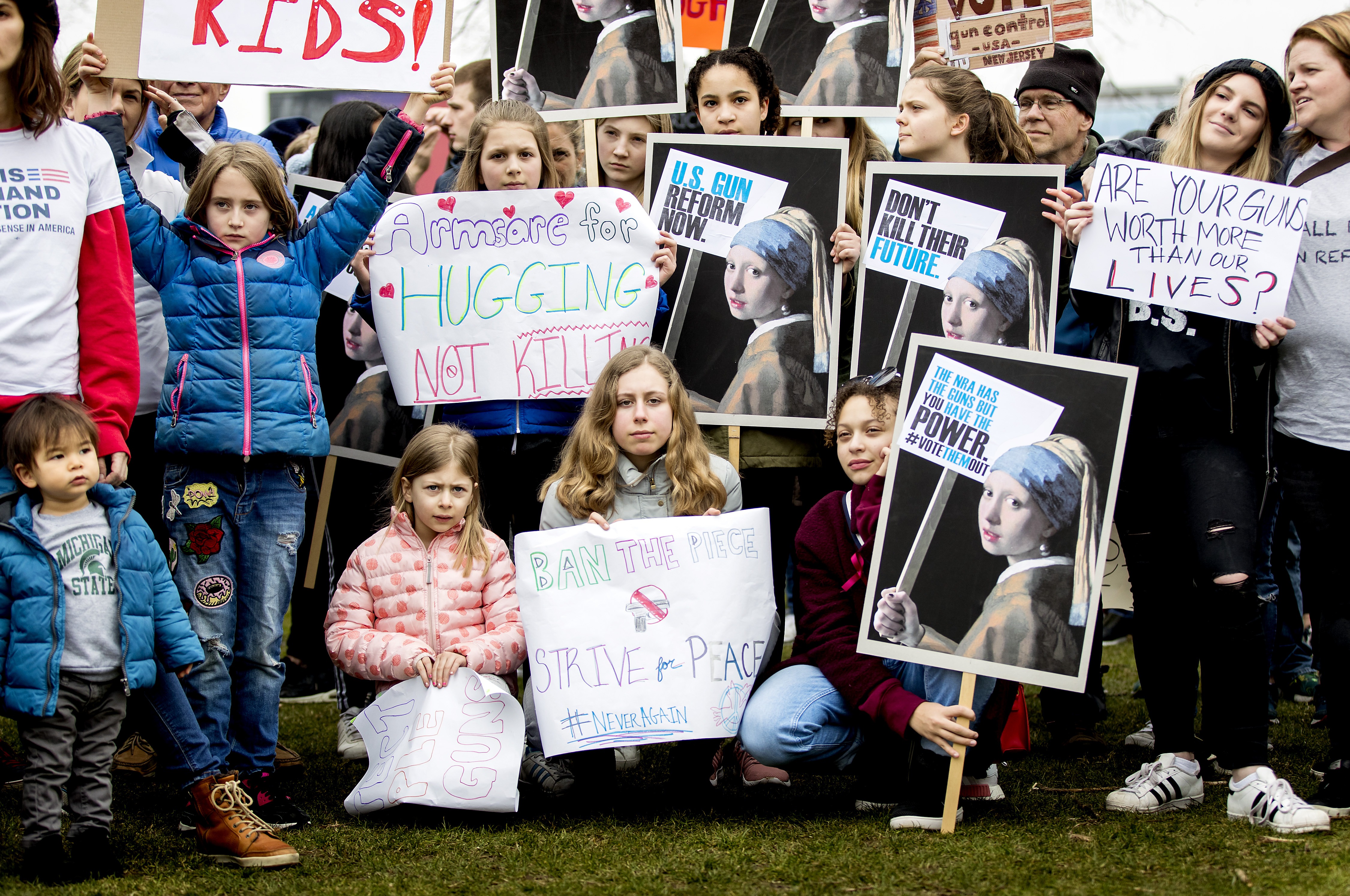 Young demonstrators hold signs during a rally calling for stronger gun control in the United States at the Museumsquare in the centre of Amsterdam on March 24th, 2018.