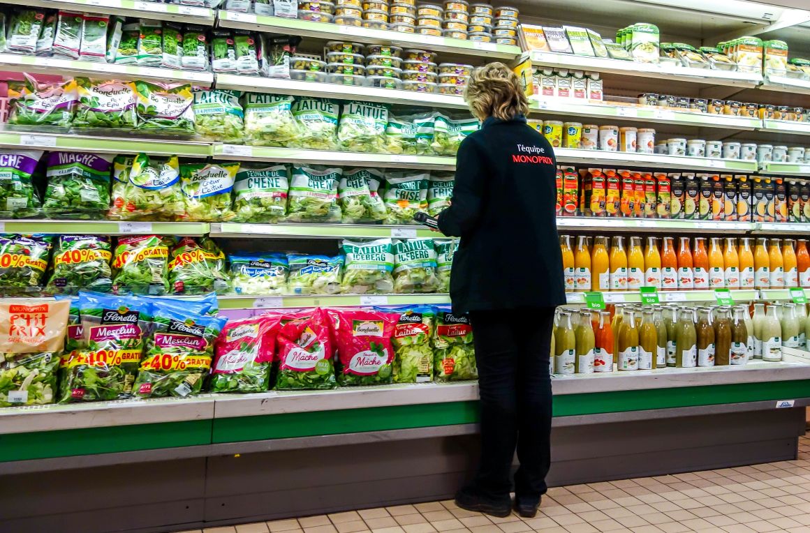 A Monoprix employee stocks items on a shelf at a location of the supermarket in Dunkirk on March 27, 2018.