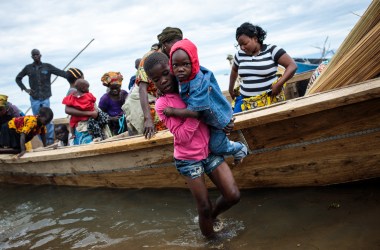 Refugees from Tchomia in the Democratic Republic of Congo arrive on boat at the Nsonga landing site on April 9th, 2018, in Nsonga, Uganda.