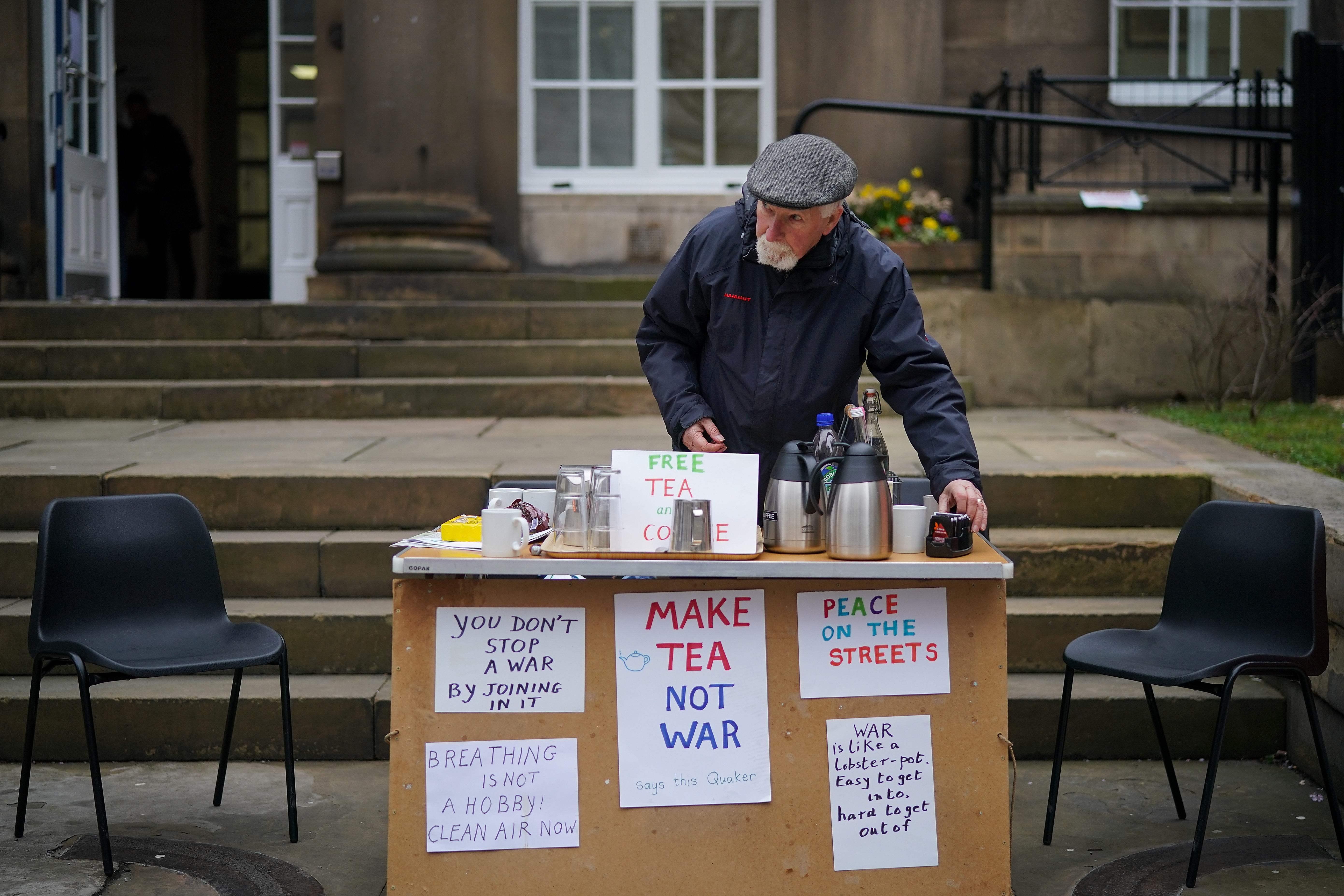 Quaker Alan Pinch makes tea for passersby as he holds a protest against war and military action in Syria on April 12th, 2018, in Manchester, England.