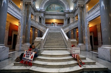 Kentucky public school teachers sit outside the House chamber as they rally for a "day of action" at the Kentucky State Capitol to try to pressure legislators to override Kentucky Governor Matt Bevin's recent veto of the state's tax and budget bills on April 13th, 2018, in Frankfort, Kentucky.