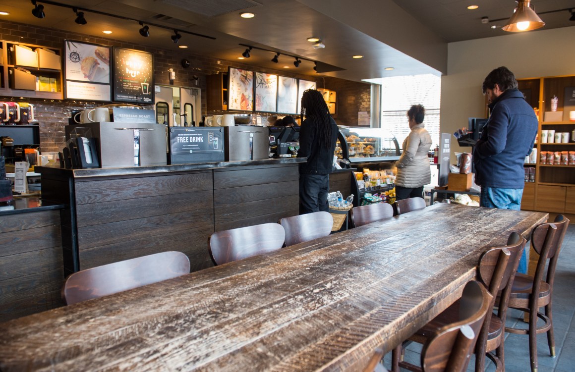 Customers line up inside a Starbucks Coffee shop.