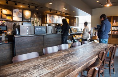 Customers line up inside a Starbucks Coffee shop.