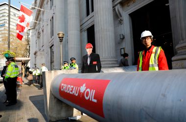 Demonstrators use a mock oil pipeline to block the entrance to the Canadian Embassy in central London on April 18th, 2018, as they protest against the Trans Mountain oil pipeline from Alberta's oil sands to the Pacific Ocean.