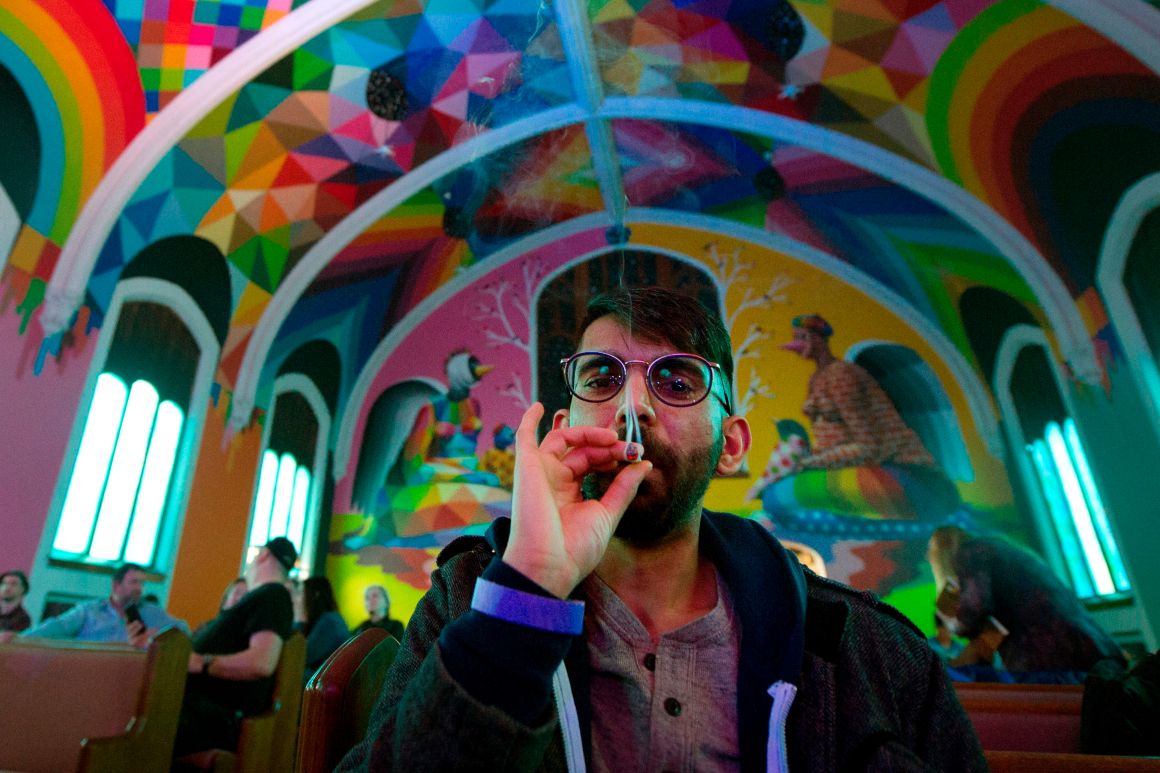 Tushar Mallick of England, a member of the International Church of Cannabis, smokes a joint during a 4/20 celebration on April 20th, 2018, in Denver, Colorado.