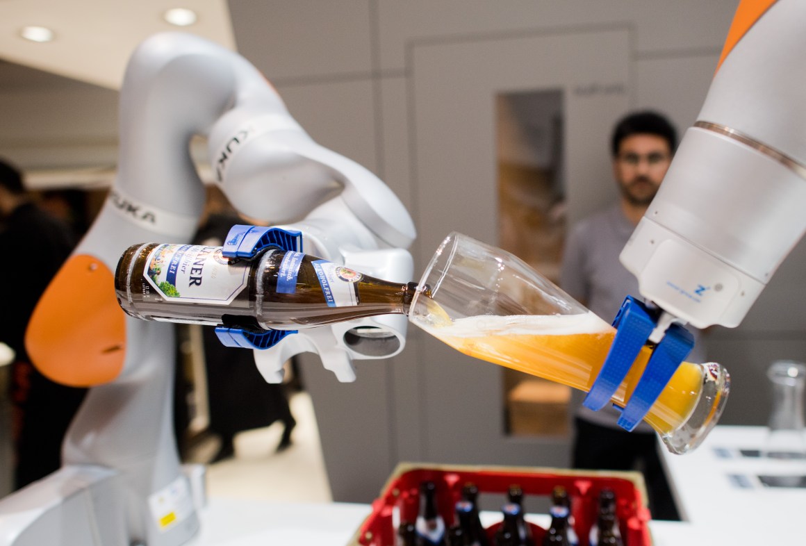 Robots from the company Kuka serve non-alcoholic beer during the Hannover Fair on April 23rd, 2018, in Hanover, Germany. The Hanover technology fair runs until April 28th, 2018, with Mexico as a partner country.