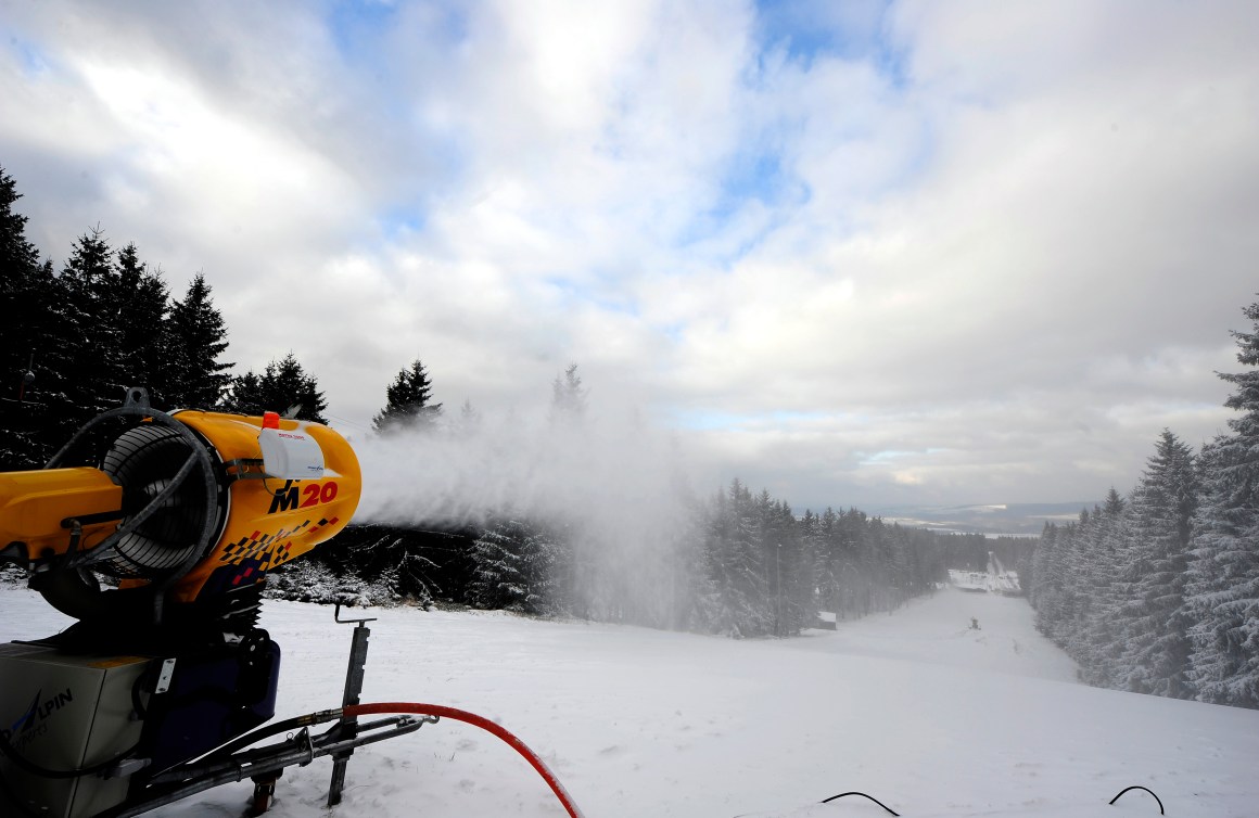 A snow cannon blowing snow onto a ski slope.