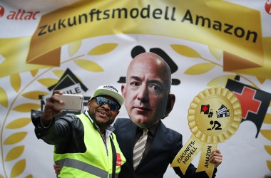 An Amazon warehouse worker shoots a selfie with an activist dressed as Amazon's Jeff Bezos during a protest outside the Axel Springer Building on April 24th, 2018, in Berlin.