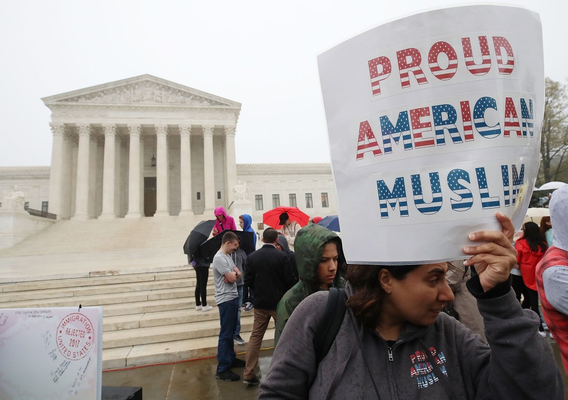 People gather to protest President Donald Trump's travel ban in front of the U.S. Supreme Court, on April 25th, 2018, in Washington, D.C.