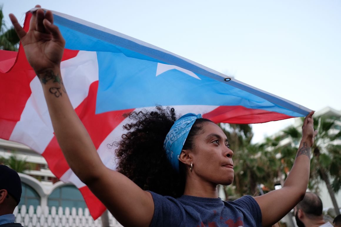 A woman displays the Puerto Rican flag in in San Juan, Puerto Rico, on May 2nd, 2018.