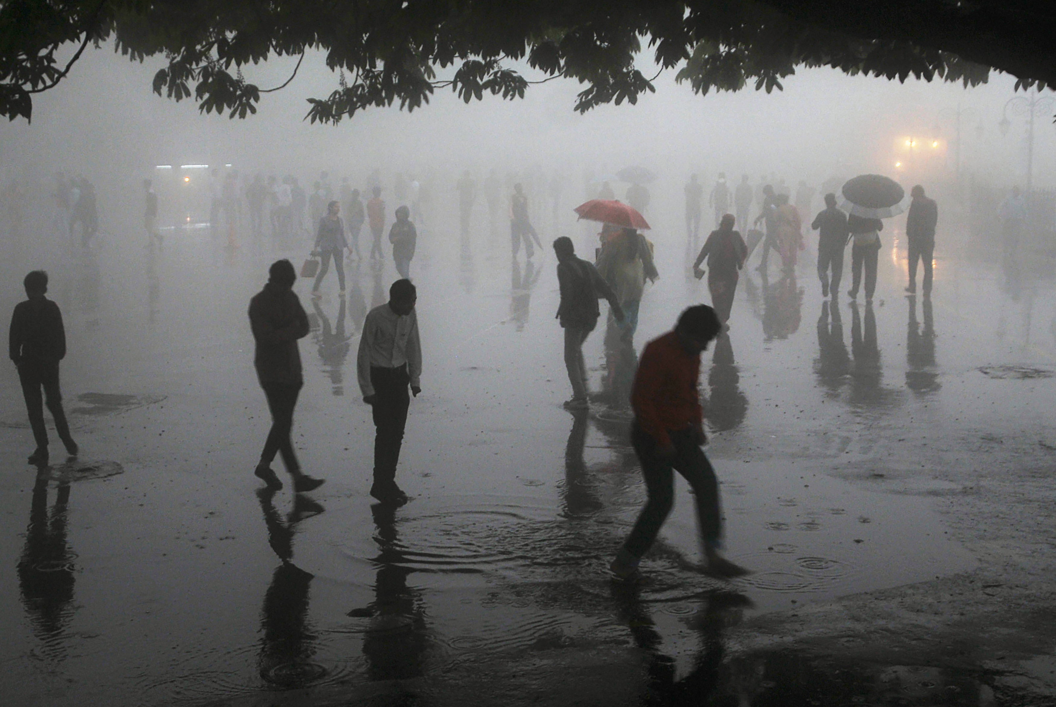 People walk under heavy rainfall in the northern hill town of Shimla in Himachal Pradesh state on May 2nd, 2018.