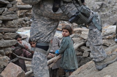 Afghan children look at a U.S. soldier in the mountains of Nuristan Province on December 19th, 2009.