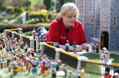 Legoland employee, Lucy, poses putting a Lego model of U.S. actress Meghan Markle in place next to her husband-to-be Britain's Prince Harry outside a Lego-brick model of Windsor Castle at Legoland in Windsor on May 8th, 2018, during a photo call for its attraction celebrating the upcoming royal wedding. Prince Harry and Markle will marry on May 19th at St. George's Chapel.