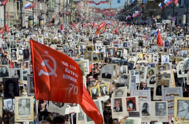 People carry portraits of World War II soldiers during the immortal regiment march, in which Russia marks the 73rd anniversary of the Soviet Union's victory over Nazi Germany, in downtown Saint Petersburg on May 9th, 2018.