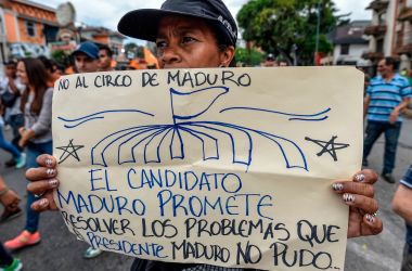 "No to the Maduro circus. The candidate Maduro promises to solve the problems that the President Maduro could not." An opponent of Venezuelan President Nicolas Maduro demonstrates in front of the Organization of American States offices in Caracas on May 16th, 2018.