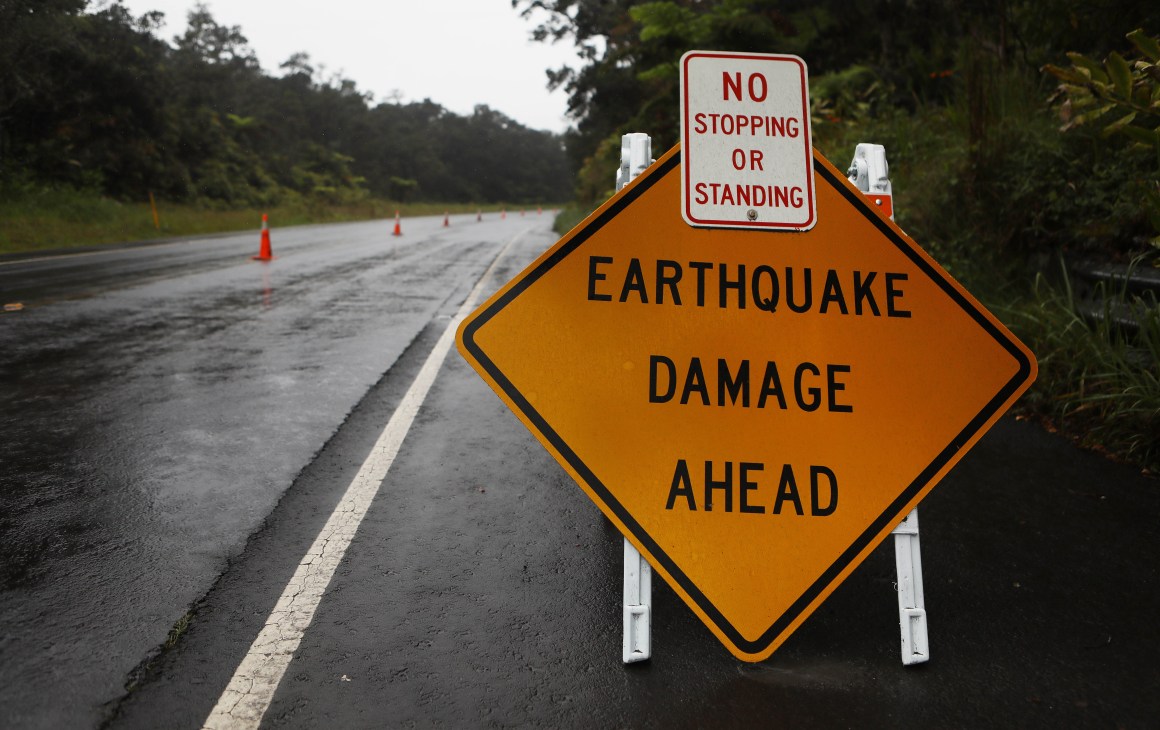 A sign is posted warning of earthquake damage to the road from seismic activity at the Kilauea volcano on Hawaii's Big Island on May 17th, 2018, in Hawaii Volcanoes National Park, Hawaii.