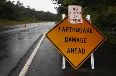 A sign is posted warning of earthquake damage to the road from seismic activity at the Kilauea volcano on Hawaii's Big Island on May 17th, 2018, in Hawaii Volcanoes National Park, Hawaii.