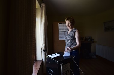 Maureen Ui Fhearraigh casts her ballot paper as voting takes place a day earlier than on the mainland, on May 24th, 2018, in Gola Island, Ireland.