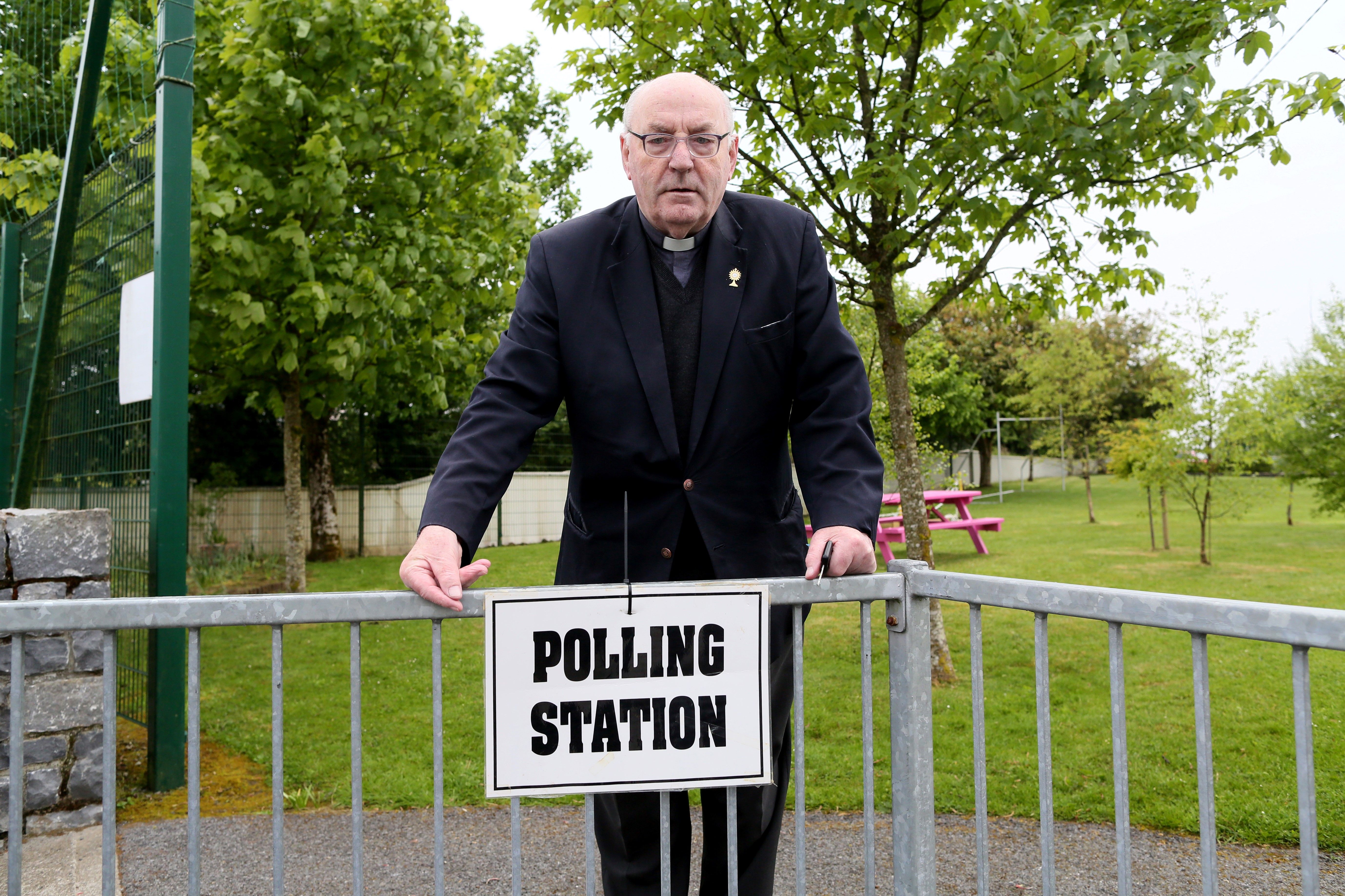 Father Tom Harrington poses for a photograph as he leaves a polling station after voting in the Irish abortion referendum, in Knock, northwest Ireland, on May 25th, 2018.