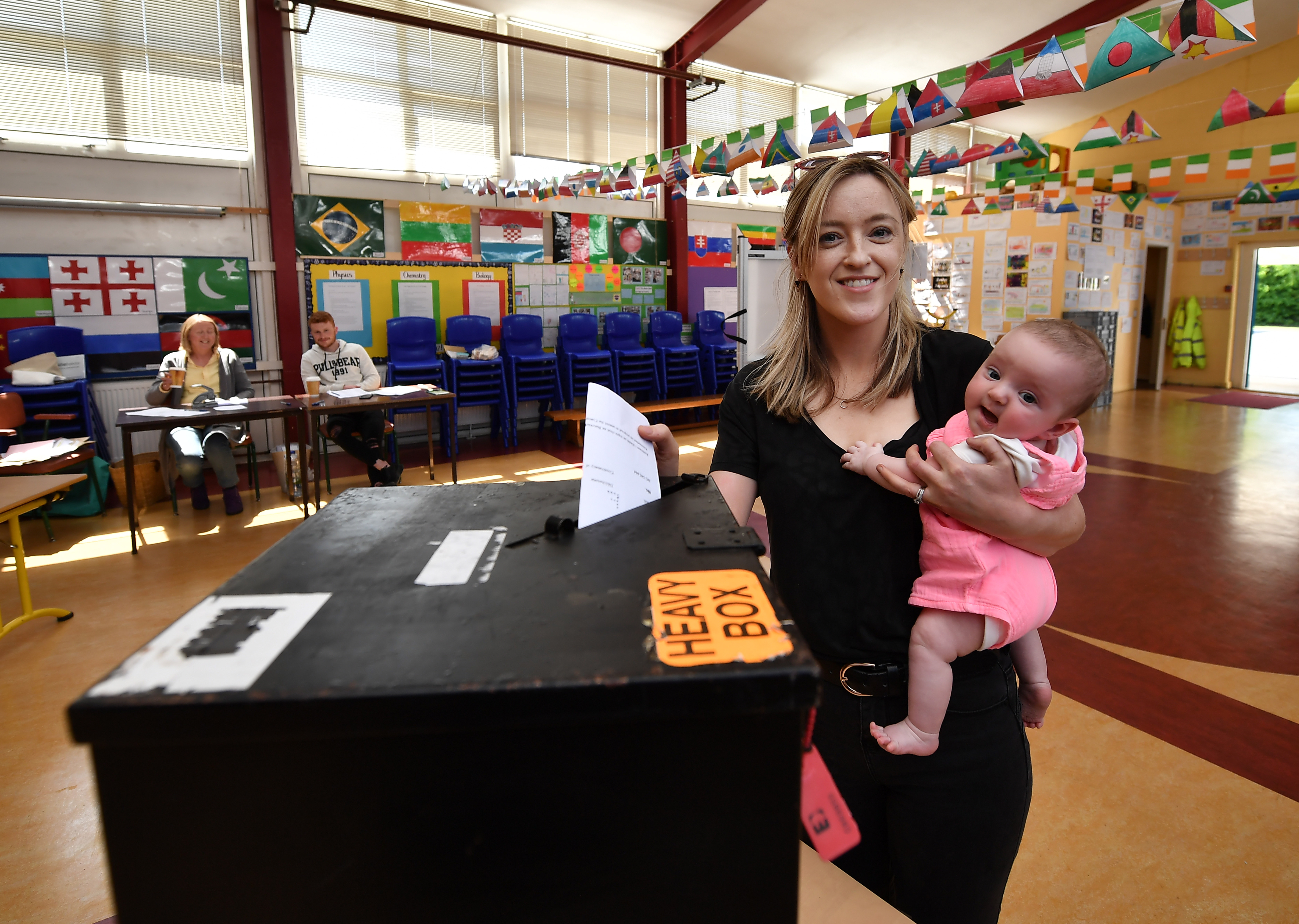 Niamh Gavin casts her vote as she holds her daughter Fiadh, aged five months, at a polling station on May 25th, 2018, in Athlone, Ireland.