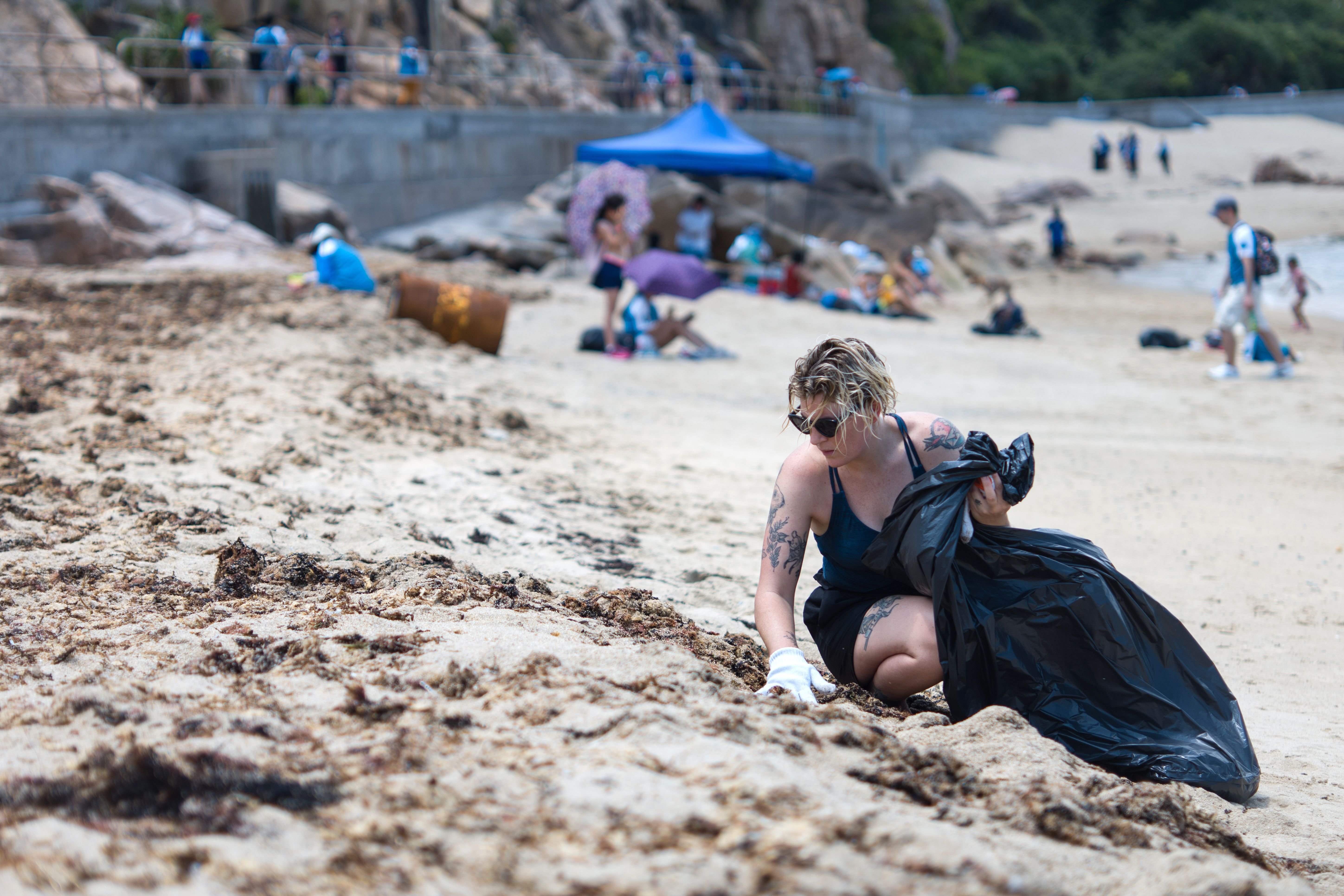 A participant takes part in a beach clean-up on Hong Kong's outlying Lamma island on May 27th, 2018. More than two thousand volunteers hit the beach on an outlying island of Hong Kong for a mass rubbish clean-up on May 27th as environment campaigners warned plastic is killing sea turtles and other wildlife.