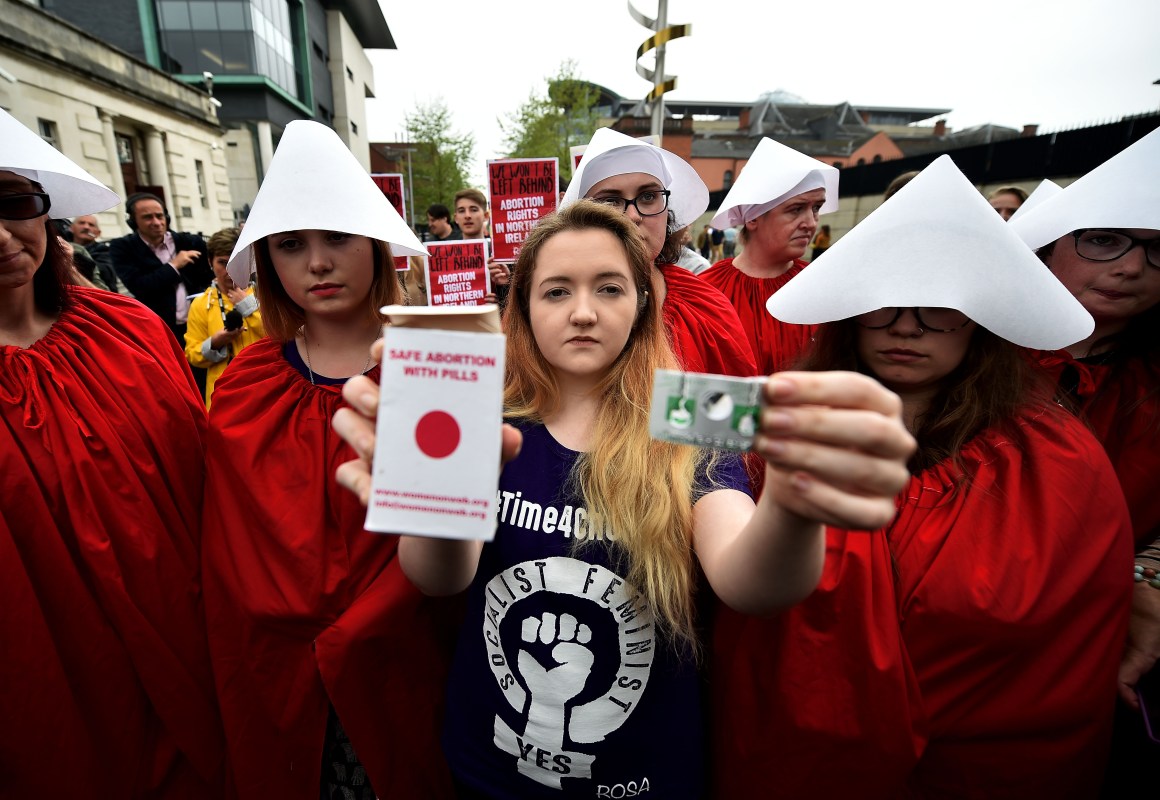 Eleanor Crossey Malone displays an abortion pill packet in Belfast, Ireland.