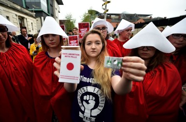 Eleanor Crossey Malone displays an abortion pill packet in Belfast, Ireland.